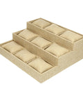 Slick Nine Grid Linen Watch Organizer Tray With Snug Padded Pillows set on a dresser, khaki fabric with multi-tier design.