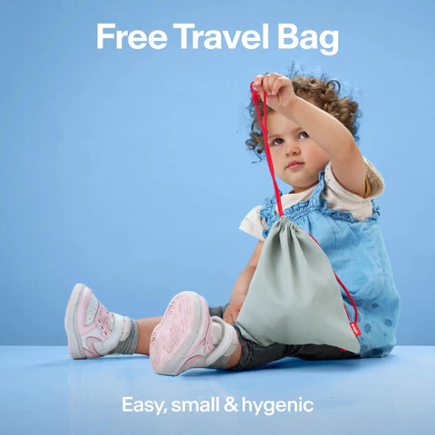 Toddler holding a free travel bag, showcasing easy, small, and hygienic design in light blue background.