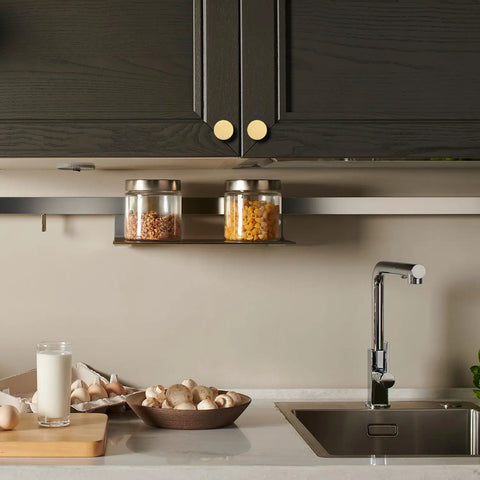 Solid Brass Round Cabinet Knobs 4 Pack on dark kitchen cabinets above sink with countertop items, 1.26 Inch Diameter By 0.78 Inch.