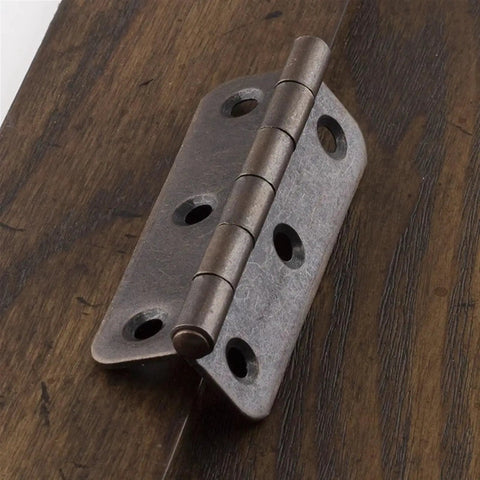 Close-up of 3 Inch Antique Copper Iron Round Corner Hinges For Cabinet Doors Built Tough Open 270 Degree Furniture Hinge on wood