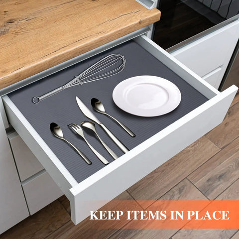 Non Adhesive Shelf Liner For Kitchen Cabinets And Drawers Features Washable Anti Slip Patterns. Dark gray EVA mat with kitchen utensils in drawer.