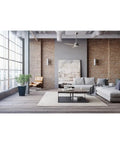 6 Inch Cylinder Outdoor Wall Sconce Two Light Up And Down Slick Modern Exterior And Interior Lighting Aluminum Construction Metallic Gray For Porch Patio Deck Weather Resistant against a brick wall in a modern living room.