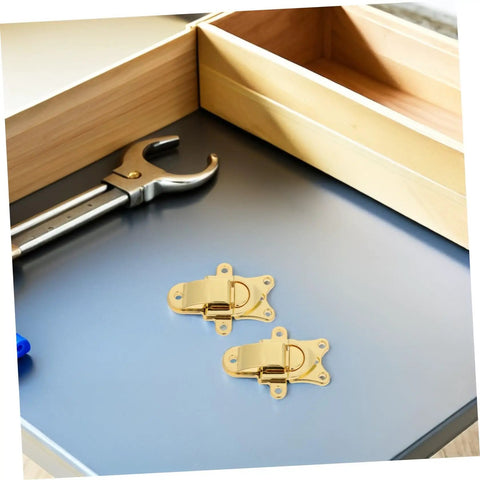 Retro Golden Metal Duckbilled Hasp Lock Toggle Latch Set with tools on a table for DIY repairs and upgrades.