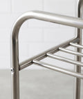 Close-up of rust-resistant metal storage rack on wheels, focus on frame detail, floor standing movable shelving unit for easy organization