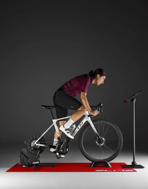 Cyclist using Rivo Direct Drive Smart Trainer for indoor cycling with accurate power, 2.5% accuracy, auto resistance, ultra quiet setup