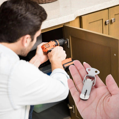Heavy Duty 6 Set Spring Loaded Toggle Latches With Mounting Screws, stainless steel clamp in a hand during cabinet installation using a drill.