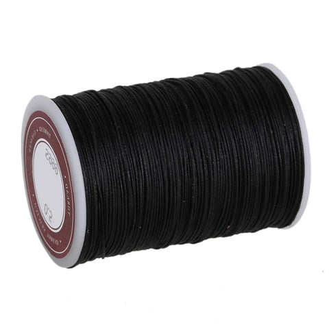 Rock Solid Waxed Thread For Leather Sewing And Bookbinding Hella Durable Half Millimeter Black Cord on a spool for crafting.