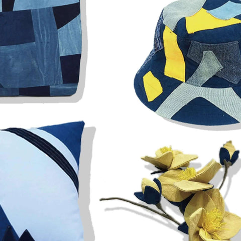 Blue patchwork pillows (3) with yellow artificial flowers.