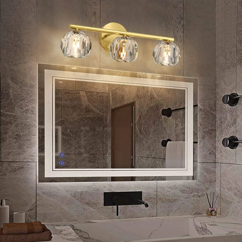 Three Light Gold Brass Vanity Light Fixture With Clear K9 Crystal Glass For Bathroom Over Mirror Modern Wall Sconce 120V G4 Base Lit Glow That Elevates Your Space And Keeps It Bright above a bathroom mirror