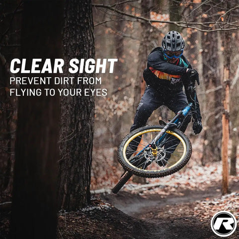 Mountain biker wearing protective gear on trail, featuring Front Big Bike Fender For Face Protection And Fork Shield Keeps You Clean And Dry On Enduro Trail All Mountain Cross Country Freeride Downhill And E Bike Rides Award Winning German Design.