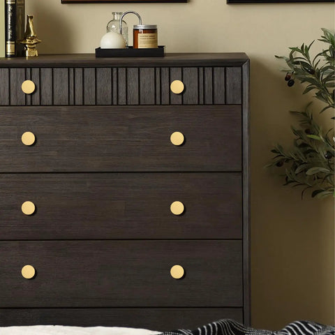 Solid Brass Round Cabinet Knobs 4 Pack, Beefy Yet Sleek Dresser Drawer Pulls on a dark wood dresser, 1.26 Inch Diameter By 0.78 Inch