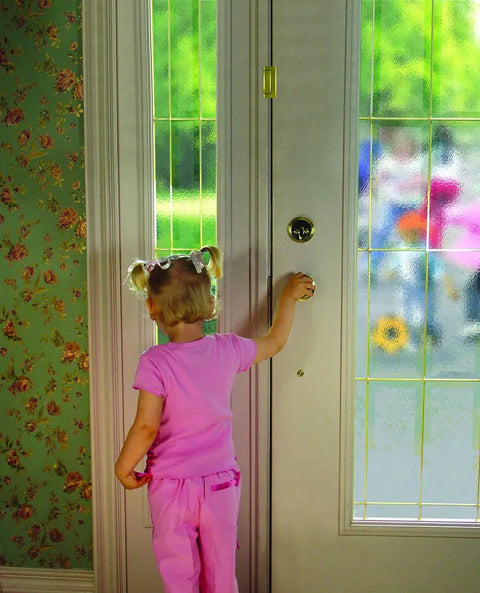 Child interacting with door featuring Tough As Nails Inward Swinging Door Reinforcement Lock For Home Security And Child Proofing No Sweat Install Extra Interior Deadbolt Secures The Spot White.