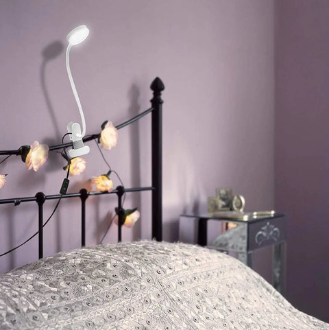 Top Shelf Clip On Reading Light With Bendy Gooseneck For Desks And Bed Rails, Slay Your Setup With Cozy LED Glow Perfect For Lazy Nights Or Fast Study Grind At Home attached to a bed frame with warm lighting.