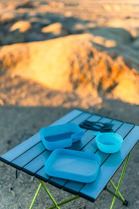 Grab And Go Self Contained Mess Kit With BPA Free Construction And All In One Eating Utensils on outdoor table in camp setting