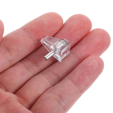 Close-up of 100 Pieces Plastic Cabinet Shelf Pegs dead easy to use locking shelf pins held in hand for bookshelves and cupboards