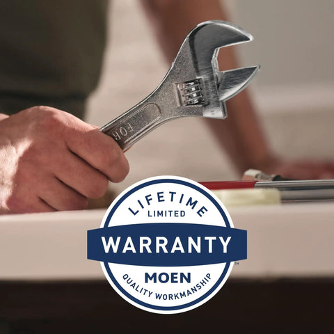 Person holding wrench near sink with warranty badge for Gibson Eco-Performance Pressure Balancing Showerhead With Matte Black Finish