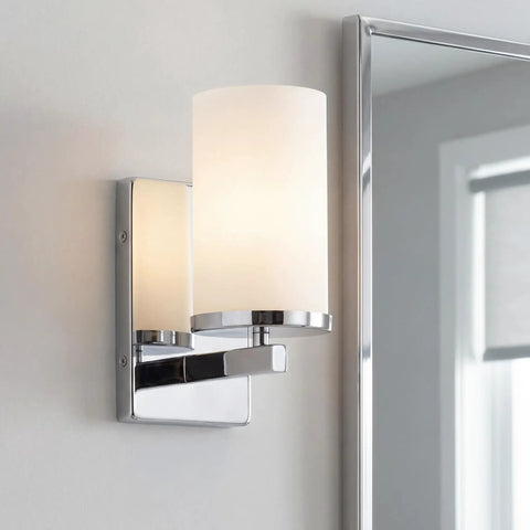 Crosby 9.25 Inch Chrome Wall Sconce With Satin Etched Cased Opal Glass 1 Light Modern Vanity Light mounted by a mirror
