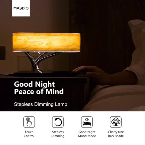 Tree Of Aura Smart Bedside Lamp with cherry tree bark shade glowing on a nightstand, illustrating dimming features.
