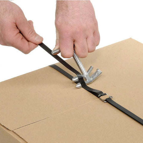 Badass Durable One Half Inch Polypropylene Strapping Kit With Three Thousand Feet Strapping Tape And Three Hundred Heavy Duty Wire Buckles Plus Manual Tensioner For No Sweat Crate Boxing And Straight Forward Bundling Tasks in use on a cardboard box.