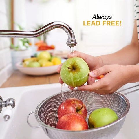 Person washing apples under faucet, showcasing stainless steel sink and lead-free water use in kitchen setting