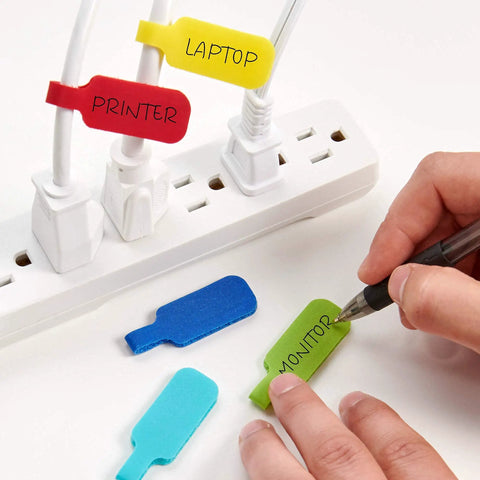 Comprehensive Cable Management Value Pack With 40 Self Gripping Ties 20 Labels And 12ft Perforated Roll For Home Office Desk Wire Organization And Quick Cord Wrap Keeps Cords Neat And Tidy, showing labeled power cords using colorful tags near a power strip.