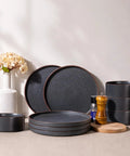 Top Tier Real Deal 12 Piece Stoneware Dinnerware Set With Sleek Matte Finish includes slate gray dinner plates and bowls.