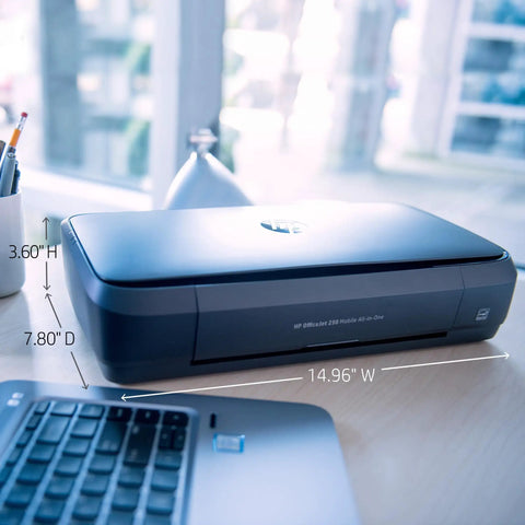 OfficeJet 250 Wireless Mobile Printer Scanner Copier With Battery Included All In One On The Go Portable Printer shown on a desk next to a laptop.