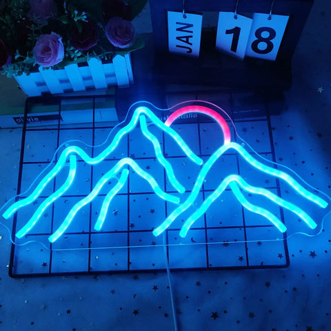 Mountain-shaped blue and red neon sign on grid background with flowers and date blocks