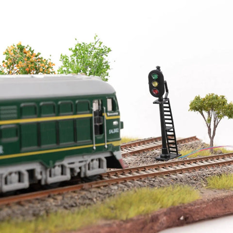 Badass 5 Piece Ho Scale 3 Light Block Signal Set Hella Durable Brass Prewired LED Railroad Lights With Red Yellow Green Bulbs 6.5cm Height For Model Trains 12V To 18V Powered Sick Upgrade For Any Layout Setup Totally Ready To Rock with train and signal in rural setting.
