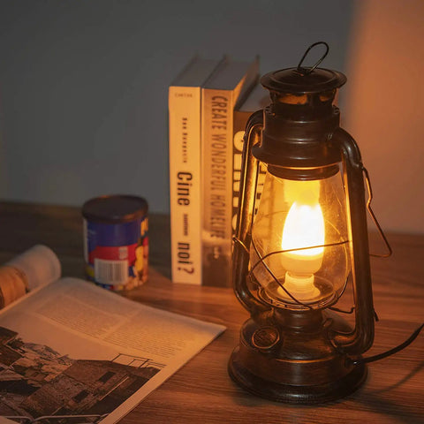 Pack Of 2 Vintage Rustic Lantern Lamps With Edison LED Bulbs, Bronze Rust Finish, on a nightstand beside a book and canister