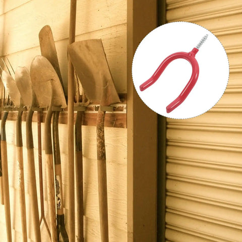 Real Deal Heavy Duty U Shaped Garage Storage Hooks For Shovels And Rakes mounted on wall holding gardening tools in garage.