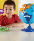 Child with Hands On 3D Puzzle Globe For Kids Learn World Geography With Color Coded Continents And 7 Detachable Puzzle Pieces Plus Name Plates And STEM Ready Kid Friendly Educational Toy For Preschool Classrooms And Home on table