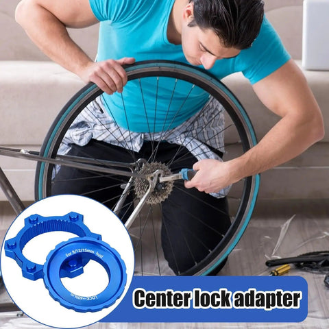 Person using Lightweight Aluminum Center Lock Tool Adapter For Bicycles Disc Brakes Simple Rotor Installation Or Removal For Road And Mountain Bikes Ideal For Travel Camping Outdoor Sports Backpacking And Everyday Maintenance on bike wheel