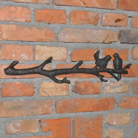 Vintage Cast Iron Tree Branch Coat Hook For Walls And Entryways Bringing Dope Rustic Vibes And Straightforward Storage Solutions That Honestly Upgrade Your Home Decor Setup mounted on brick wall with two bird accents.
