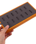 Slick Gray Solid Wood Jewelry Display Tray Featuring 12 Ring Slots top view held in hand showcasing grey felt interior for jewelry organization.