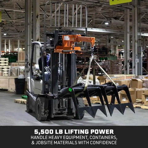 Built Tough Fork Mounted Telescoping Jib Boom Crane With 5500 LB Lifting Power And Sweet 31 To 79 Inch Reach lifting heavy equipment in a warehouse.