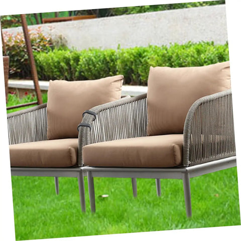 Outdoor seating with brown cushions and silver frames in a garden setting, secured with 24 Pack Outdoor Furniture Clips For Sectional Sofas And Wicker Chairs.