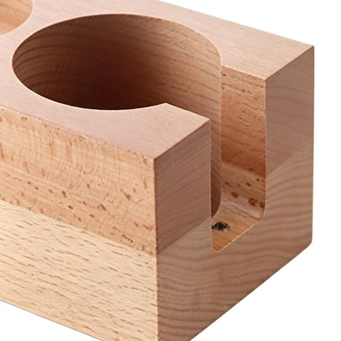 Close-up of the Premium 58 Mm Espresso Tamping Station crafted from warm natural wood with rounded cup holder.