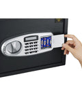 Hand inserting batteries in Drop Safe For Cash Drops With Digital Keypad And Two Manual Override Keys Wall Or Floor Mounted Electronic Safe Deposit Box