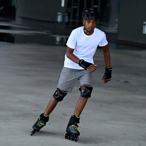 A man skating with Macroblade 80 Inline Skates For Men With Dope Fit Performance Liner Engineered Mesh Comfortable Padding in black and lime.