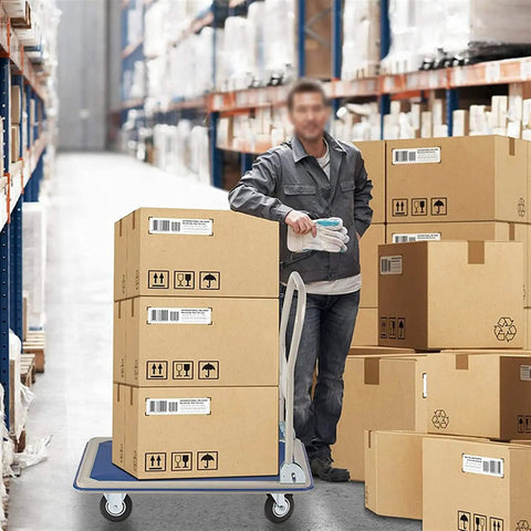 Heavy Duty Folding Platform Truck And Portable Hand Cart For Warehouse Moves Built Tough As Nails To Haul Six Hundred Sixty Pounds No Sweat Perfect For Home Office Or Factory Tasks with stacked boxes in warehouse.