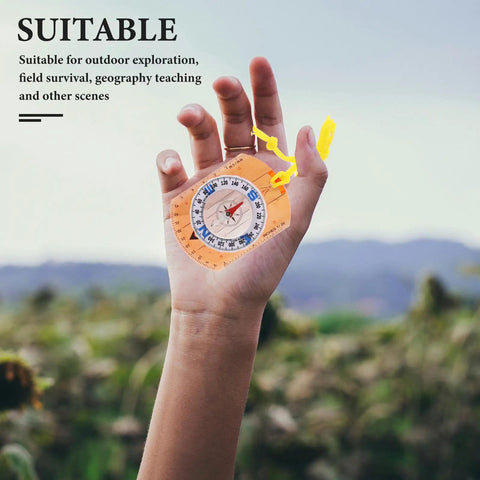 Hand holding Rugged Orange Orienteering Hiking Compass With Lanyard For Hiking Camping And Backpacking against landscape