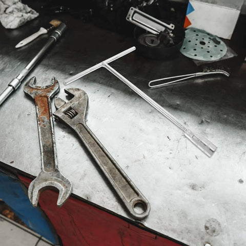 Heavy Duty T Handle Socket Wrench Set For Bike And Motorcycle Maintenance With Thick Hexagon Shaft and wrenches on a workbench.