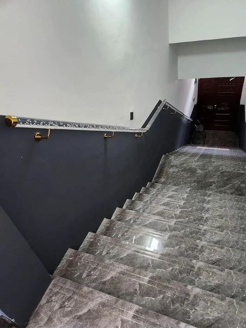 Rock Solid Super Clean Acrylic Stair Handrail With Gold Brackets And Hella Strong Non Slip Grip For Custom Wall Mount Indoor Or Outdoor Steps on a staircase.