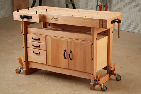 Drop Dead Heavy Workbench Caster Wheel Kit With Four Smooth Rolling Swivel Wheels And Flat Out Tough Rubber Tires For Easy Shop Floor Mobility And Bulletproof Six Two Zero Pound Capacity on a wooden workbench.