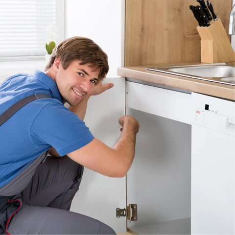 Person installing self closing cabinet door hinges with soft closure iron material in brushed satin finish in a kitchen cabinet