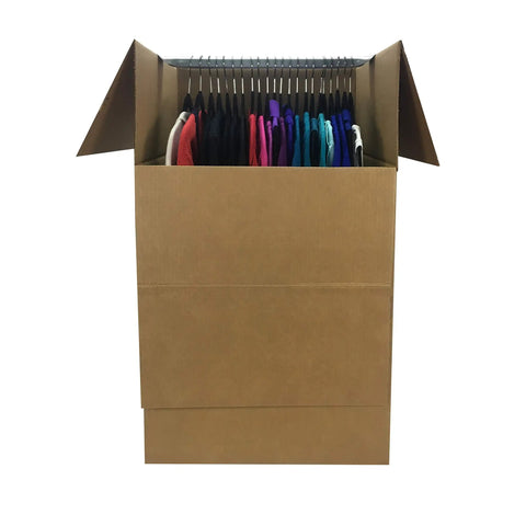 Dang Sturdy Cardboard Wardrobe Moving Boxes Featuring Heavy Duty Metal Clothes Hanger Bar Plus Durable Side Handles No Sweat Flat Setup Corrugated Storage Crates For Effortless Home Relocation 24 X 24 X 40 Inches Six Pack Bundle filled with hanging clothes.