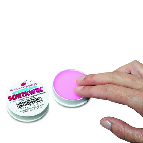 Level Up Your Daily Paper Handling With These Hella Effective Fingertip Moisteners Designed For Bank Tellers Cashiers And Office Crews To Grip Pages Smoothly Count Bills Quicker And Ace Every Task Without Stickiness. Pink fingertip moistener gel in a round container with a hand applying it.