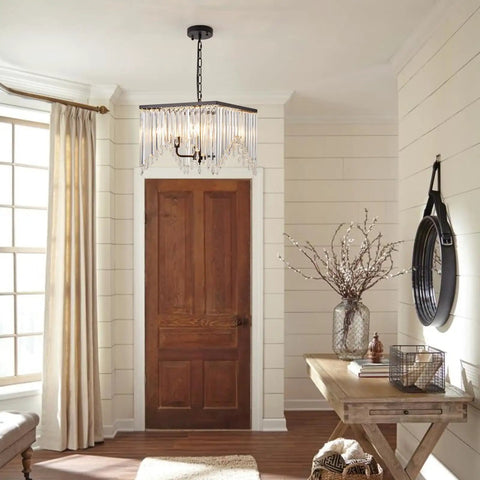 Four Light Crystal Chandelier With Black Iron Frame And K9 Clear Crystals hanging in a well-lit hallway.