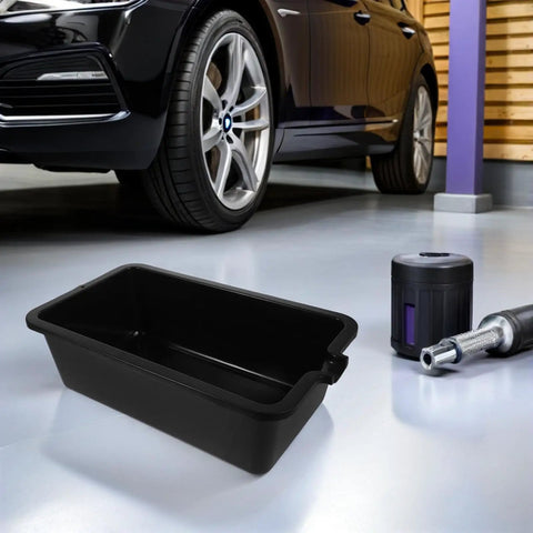 Sturdy Plastic Oil Change Pan With Wide Mouth For Effortless Draining And Recycling Of Engine Oil In Cars And Commercial Trucks For Easy Maintenance beside a car.